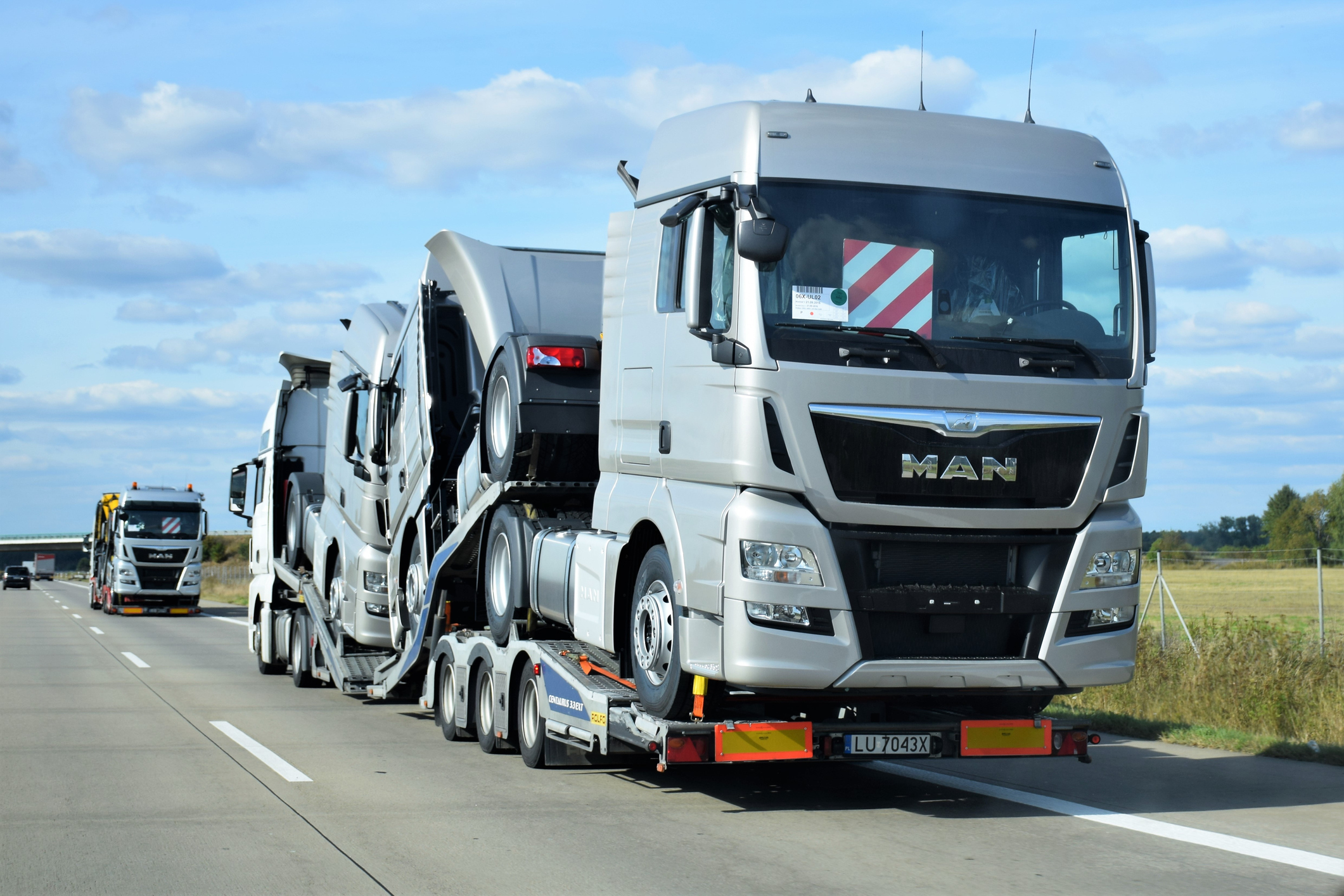 Allianz-Flottenversicherung: LKWs transportieren Zugfahrzeuge auf Ladefläche
