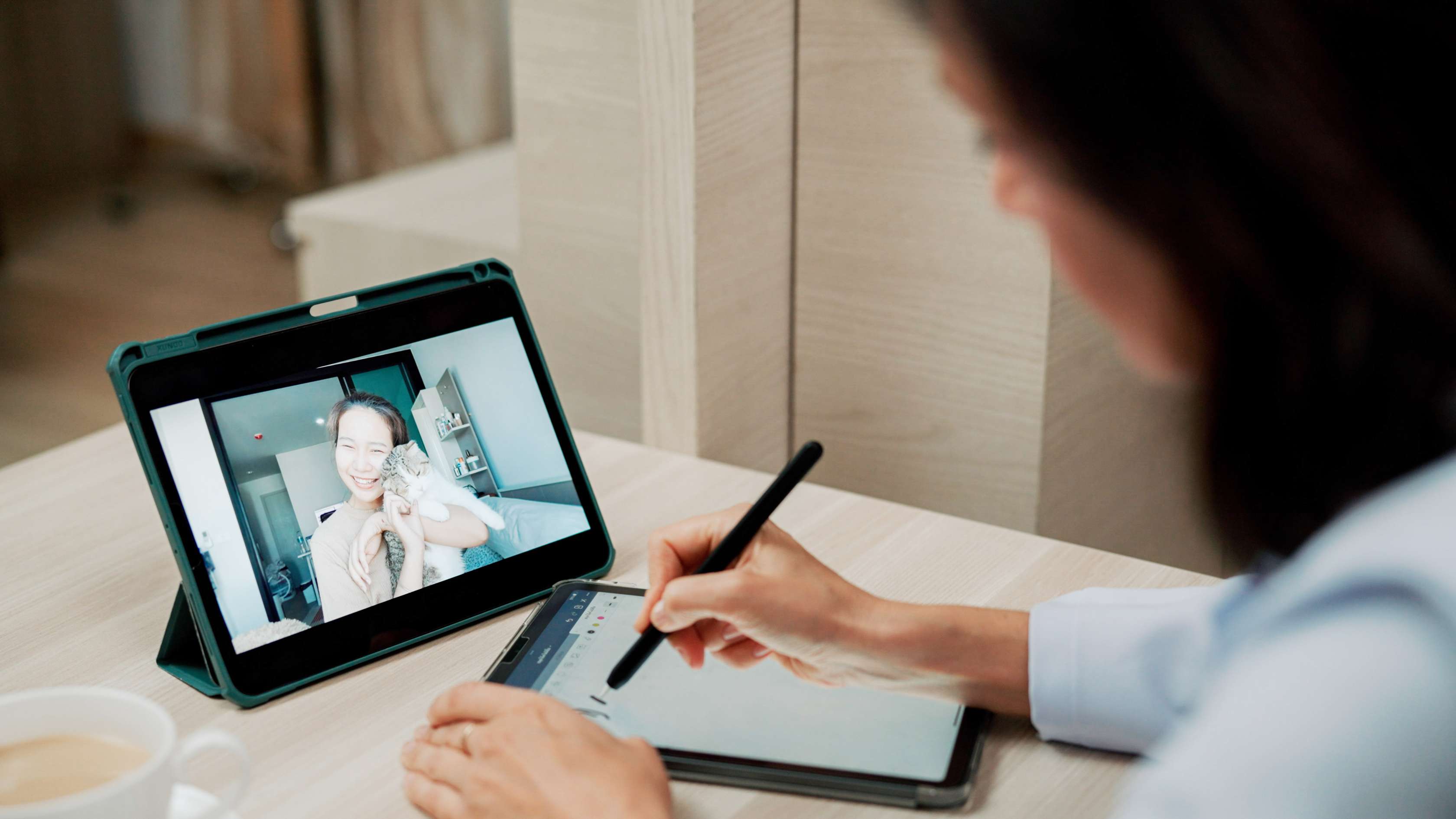 Eine Ärztin macht sich Notizen während einer virtuellen Sprechstunde