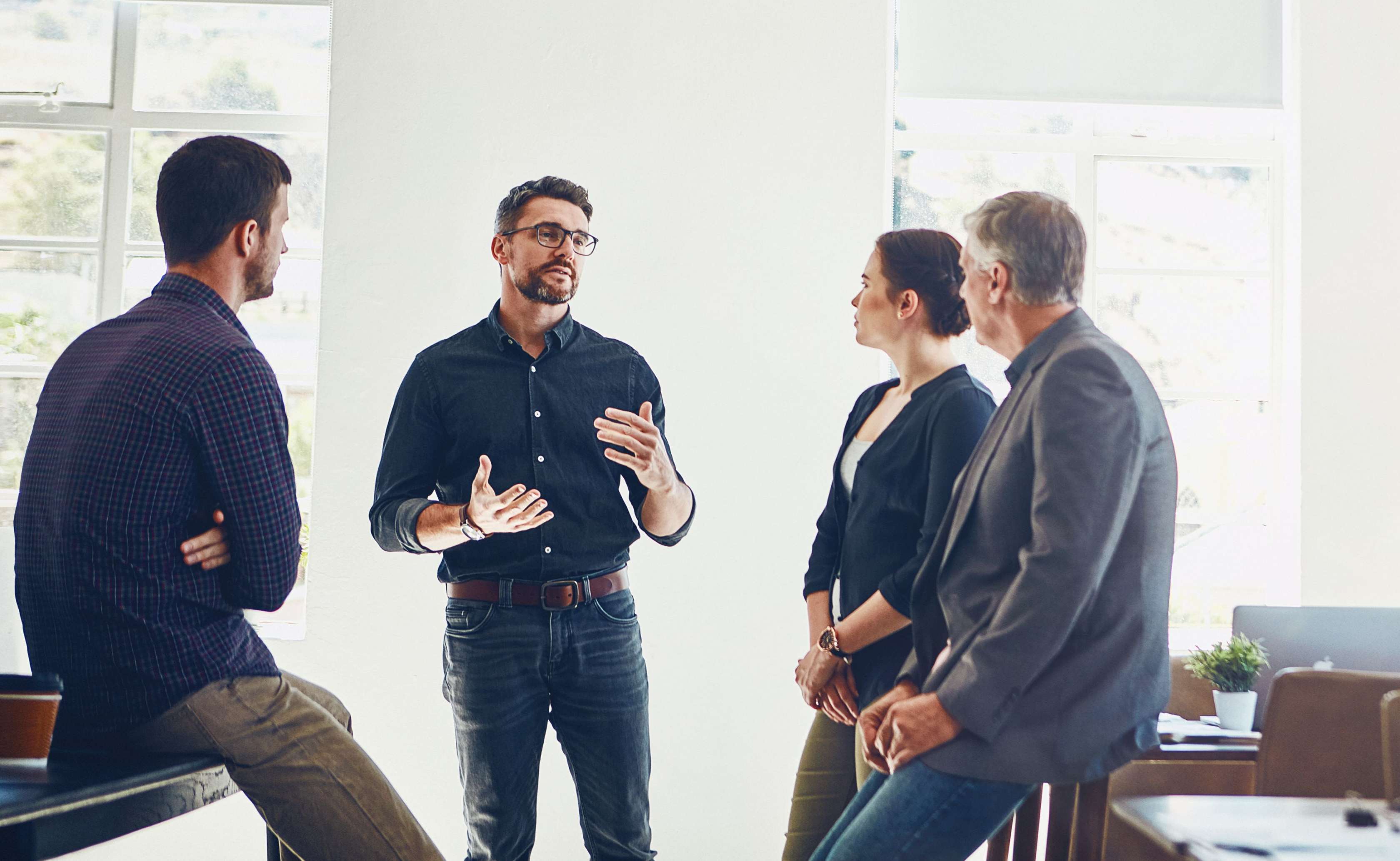 Allianz Bürgerentlastungsgesetz: Steuerliche Entlastung durch das Bürgerentlastungsgesetz. Eine Gruppe steht im Büro und unterhält sich.